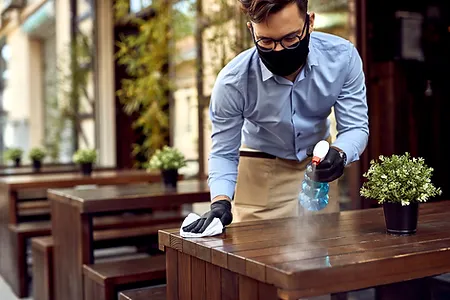 man cleaning a table